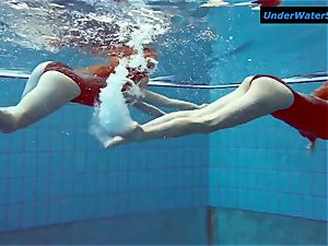 two warm teenagers underwater